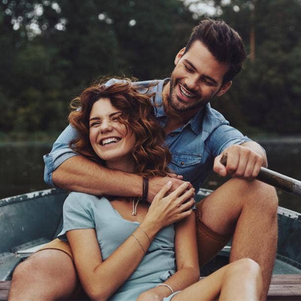 couple smiling in a boat man's arm around woman signs he's your soulmate