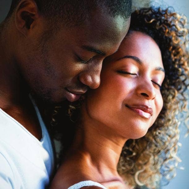 man hugging woman from behind smiling in love signs he's soulmate