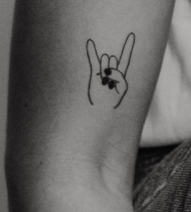 hand horns tattoo idea for women