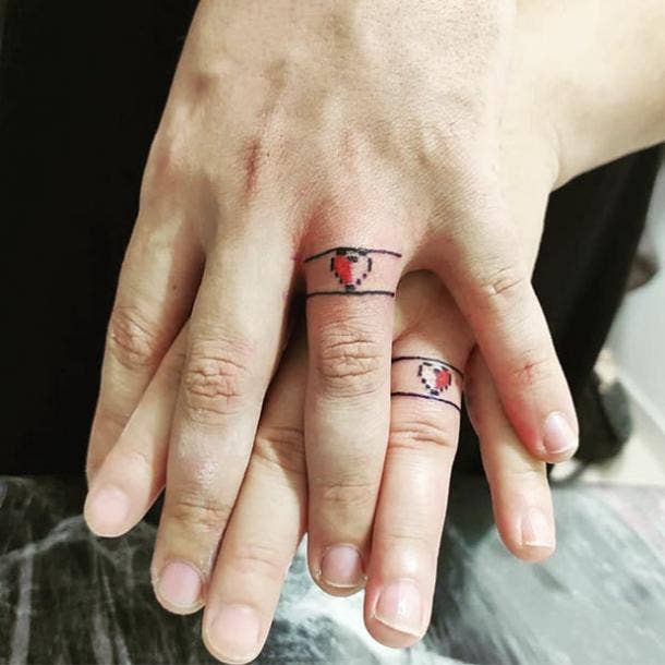 Pixel heart wedding ring tattoo
