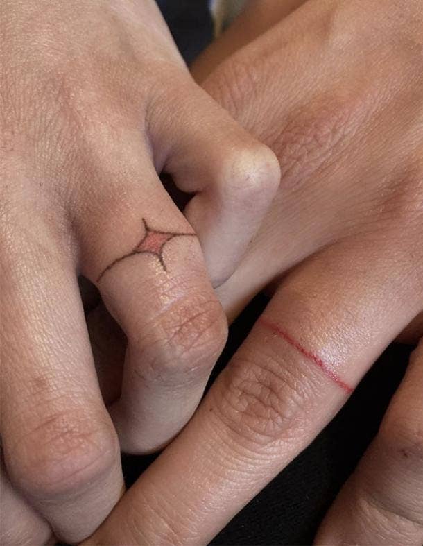 Red ink wedding ring tattoo