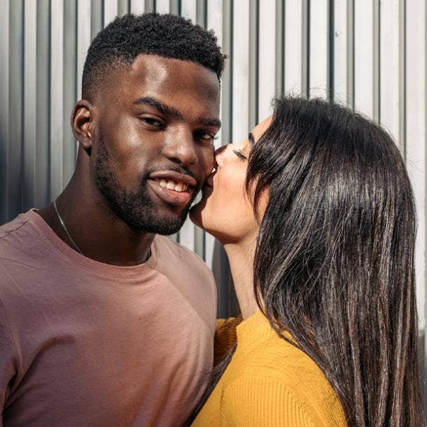 woman kissing man's cheek smiling how to kiss a guy