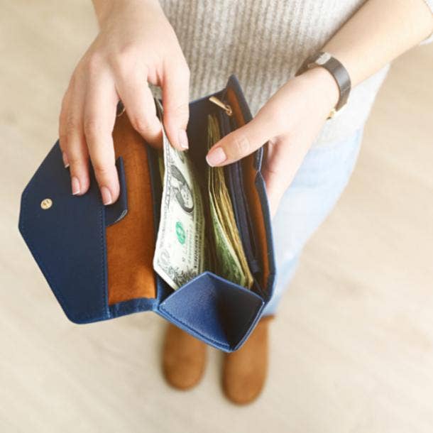 secrets women keep woman reaching into wallet for money