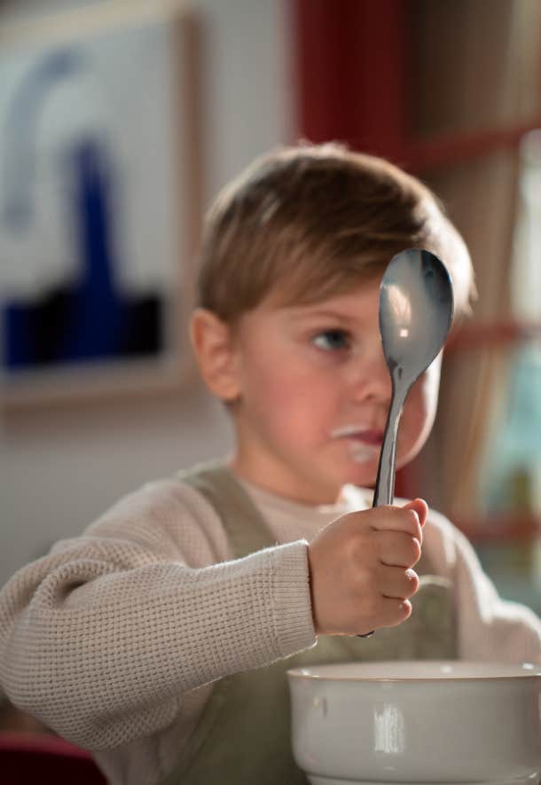 little boy holding spoon