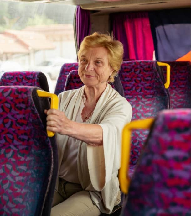 elderly woman sitting on a bus