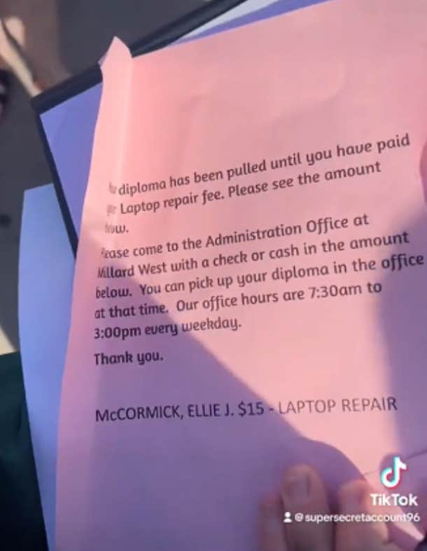 Pink slip inside the diploma cover that tells the student they need to pay a $15 fee to retrieve their diploma.