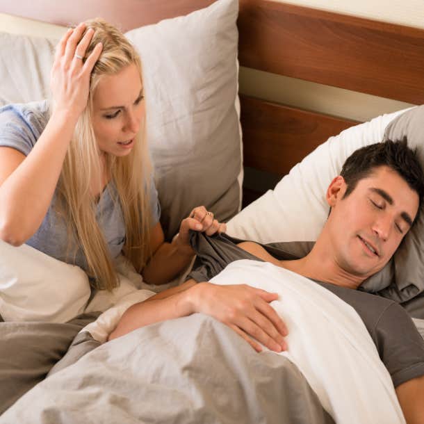 woman confronts husband in bed sleep talking
