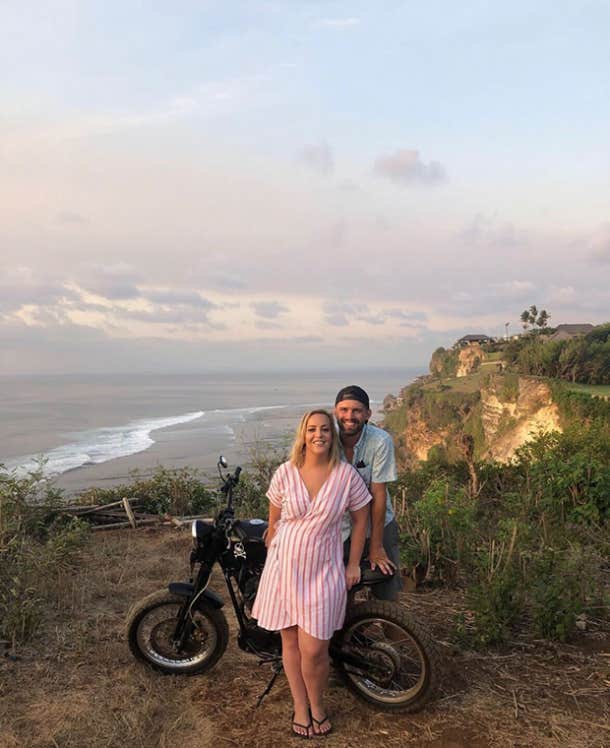 Heather and husband Austin smiling together in a photo captured in a beach in Bali