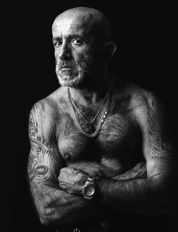 older man with arm tattoos