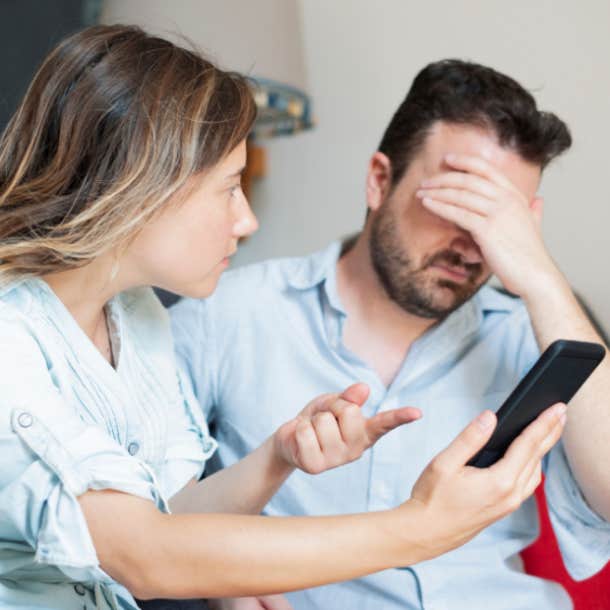 Boyfriend caught by girlfriend while cheating with mobile phone.