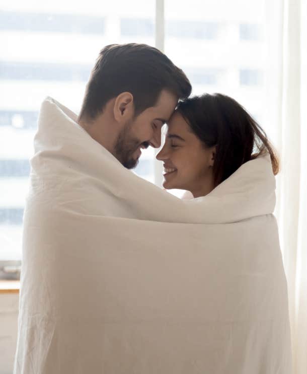 loving couple wrapped in blanket