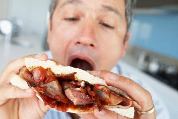 Man eating meat sandwich