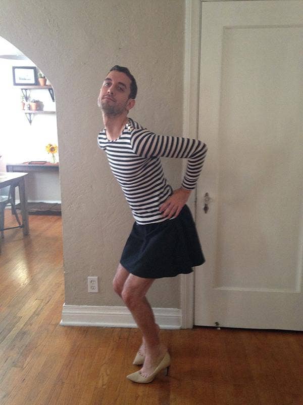 man in striped long sleeve shirt and black skirt