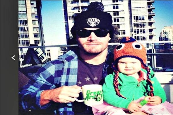 Dad and daughter in hats.