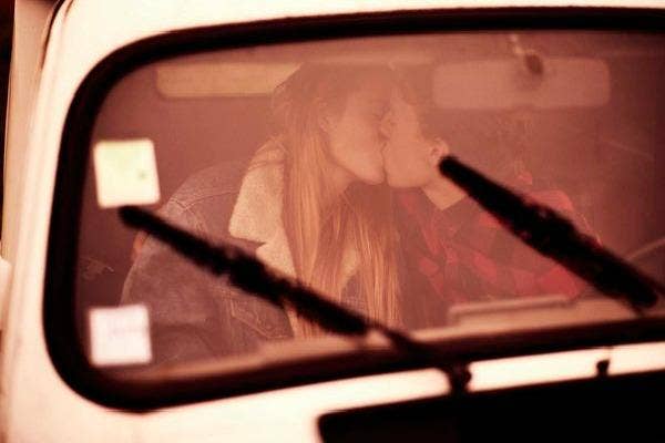 Couple in a car kissing.
