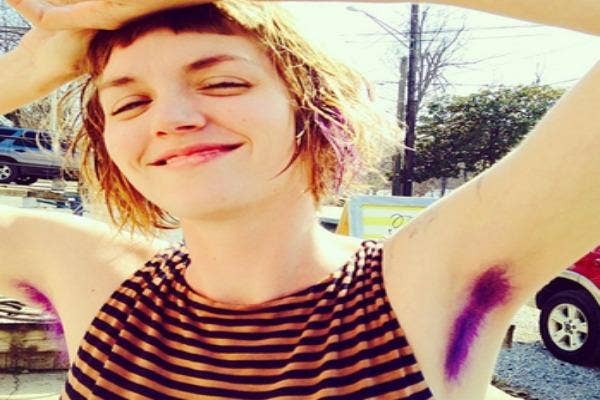 Woman with vivid purple armpit hair.