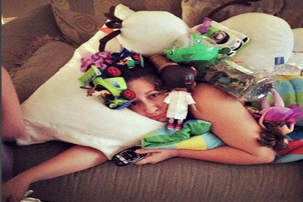 Mommy sick in bed with toys.