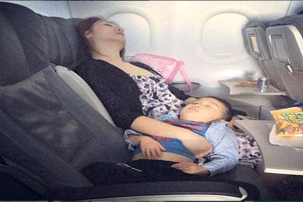 Mom and child asleep on plane.