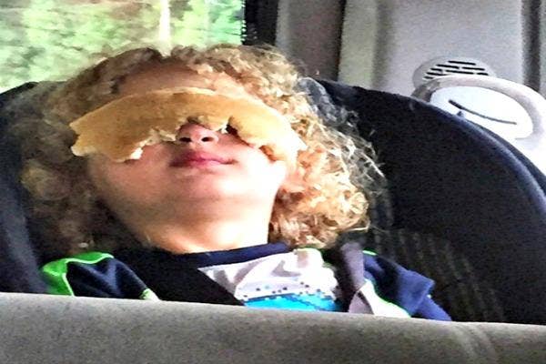 Kid with pancakes on his eyes.