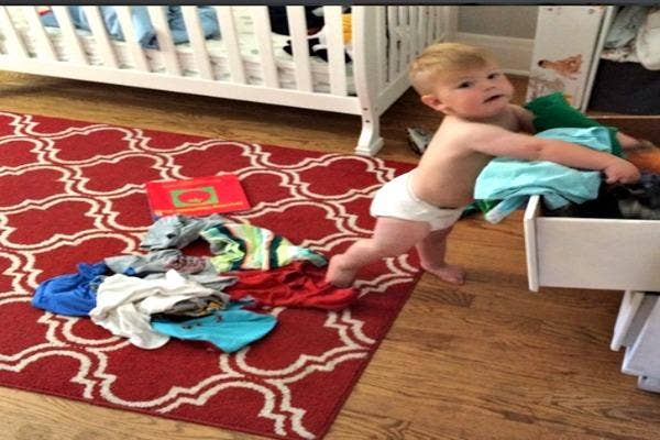 Baby pulling things out of drawers.