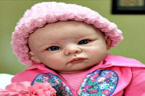 Baby doll in pink hat.