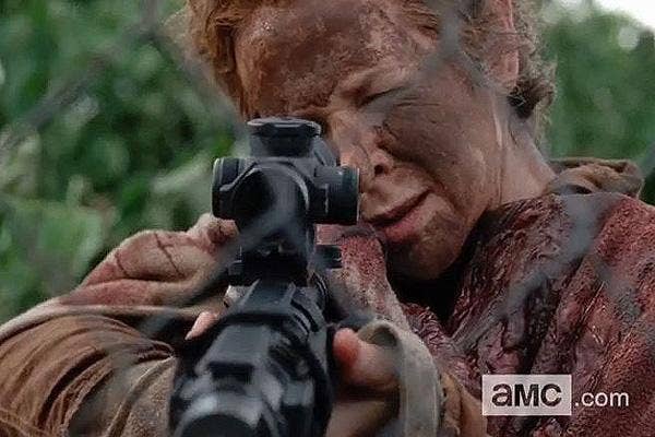 Melissa McBride as Carol Pelletier on The Walking Dead AMC shooting a machine gun