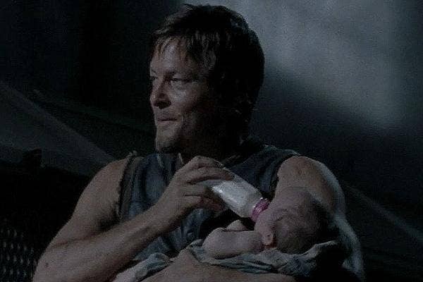 Norman Reedus as Daryl Dixon with a baby Judith (Lil Asskicker) on &#039;The Walking Dead&#039; AMC
