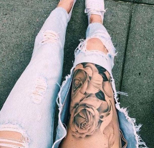 Black and white watercolor flower thigh tattoo