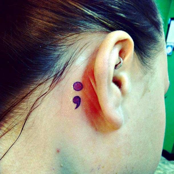 Purple semicolon behind the ear.