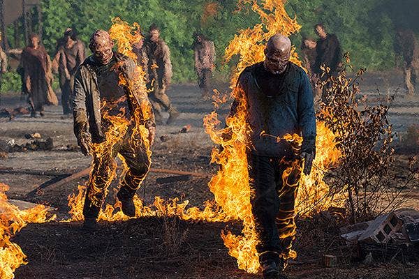 Melissa McBride as Carol Pelletier on The Walking Dead AMC with zombies on fire