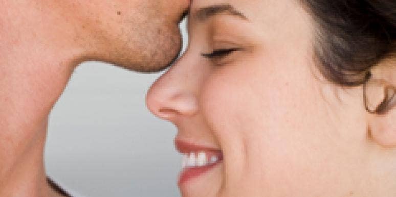 man kissing woman