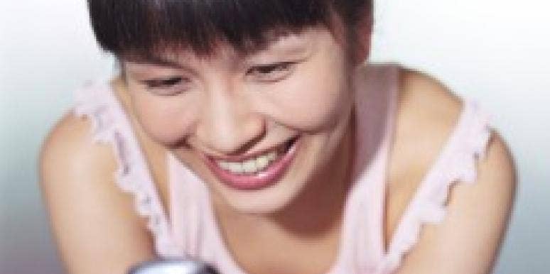 woman texting and smiling