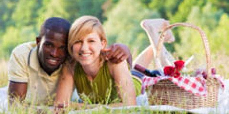 April Astrology: Brace Your Love Life For Less Talk, More Action couple lying in the grass