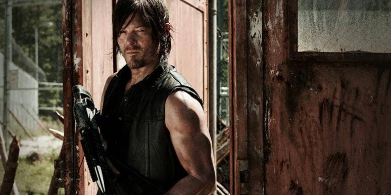 Norman Reedus as Daryl Dixon holding a crossbow and wearing his signature leather vest in AMC 'The Walking Dead' Season 5