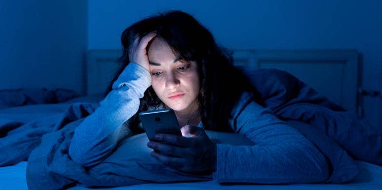 Top 6 Dating Mistakes Women Make Online That Keep Them Single woman on phone in bed