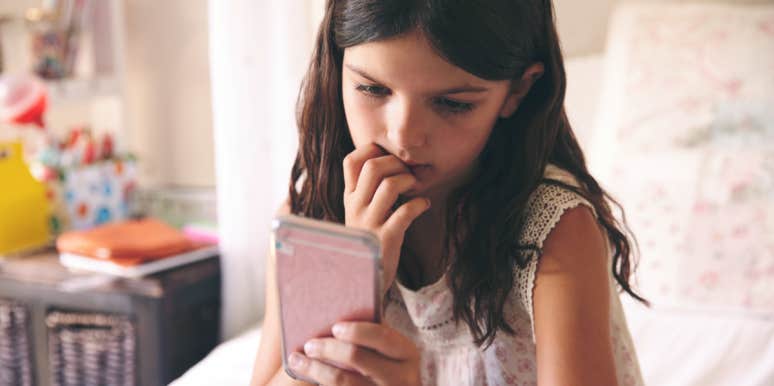 10 Struggles Only People Who Were Bullied In School Will Understand young girl looking at phone