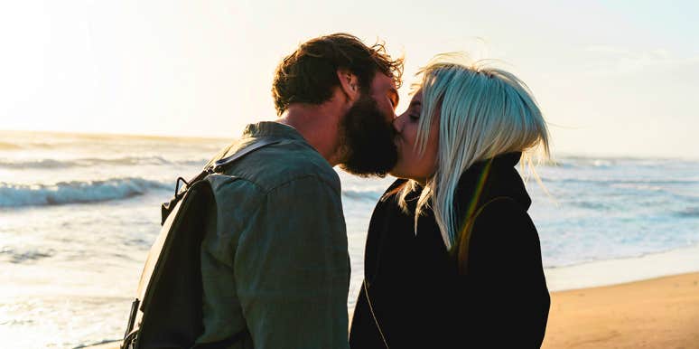 man kissing woman on beach