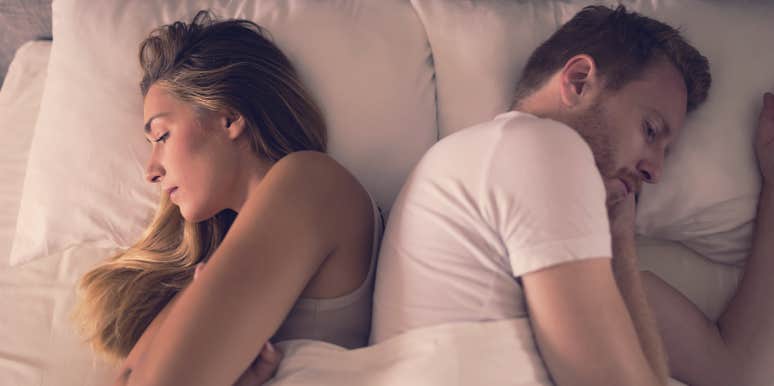 couple facing away from one another in bed