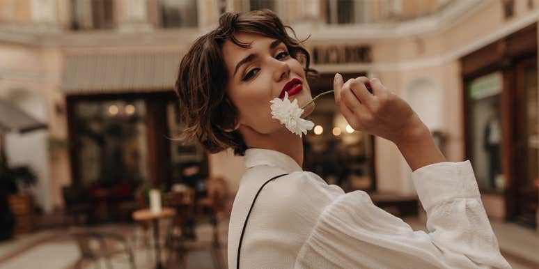 10 Women Reveal The Surprising Reason They Never Want Kids single woman holding flower