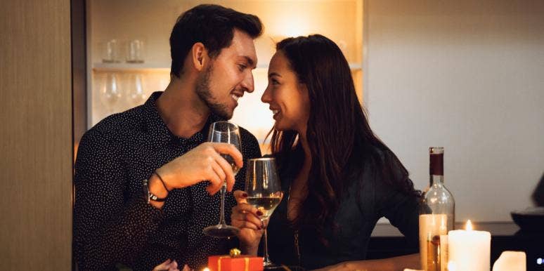 11 Indoor At-Home Date Night Ideas To Electrify Your Relationship man and woman eating dinner at home