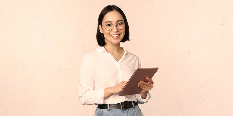 11 Life Cheat Codes I’ve Proudly Stolen From People Smarter Than Me woman holding a board