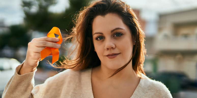 My 13-Year Journey to Get an MS Diagnosis woman holding ms ribbon