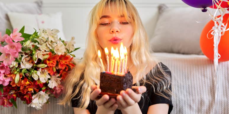 Woman destined for financial success holding birthday cake