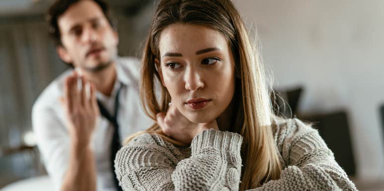 sad woman turned away from yelling man