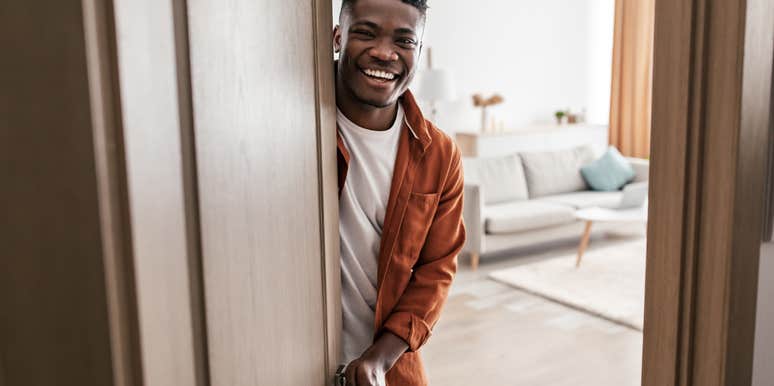 adult man opening door to apartment