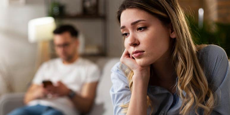 sad woman turned away from partner afraid he will leave her