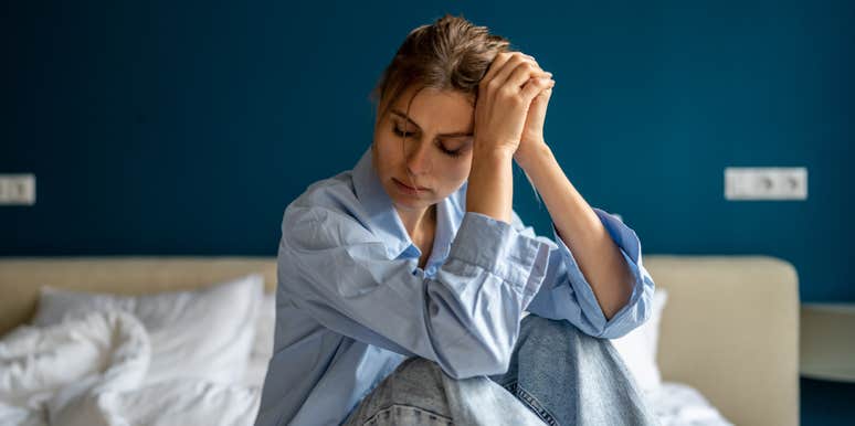 depressed woman sitting on bed
