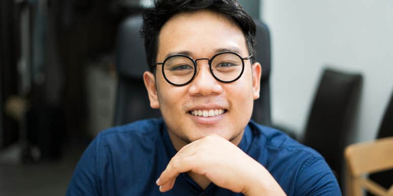 smiling young man thinking about how parents raised him right