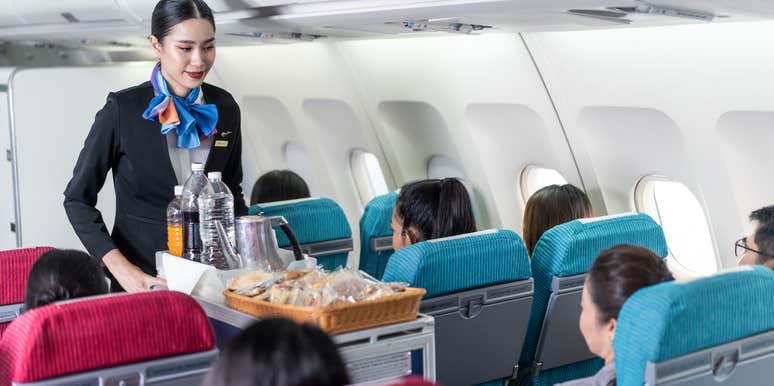 Flight attendant with drink cart