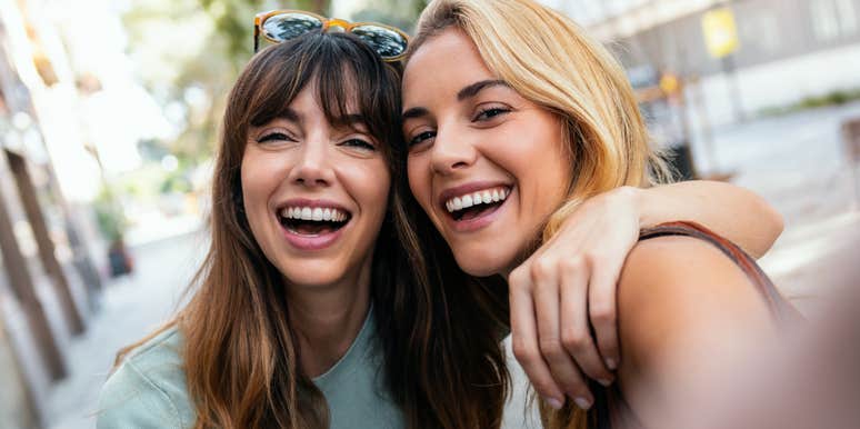 Two women look at the camera.